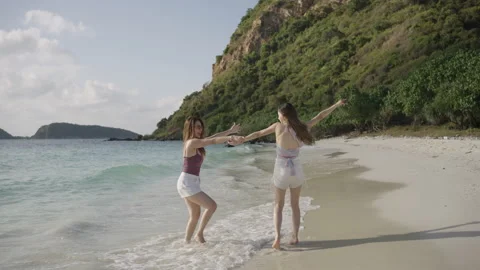 Summer vacation on the beach. Two are walking and dancing on the beach. Stock Footage 171570154
