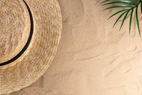 Summer vacation composition. Hat on sand background with a copy of space. Sum Stock Photos