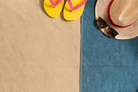 Summer vacation composition. Hat, sun cream and sunglasses on sand background Stock Photos