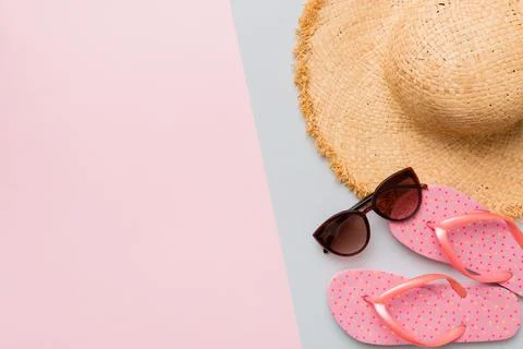 Summer vacation concept flat lay. straw hat beach accessories and flip flop t Stock Photos