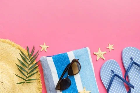Summer vacation concept flat lay. straw hat beach accessories and towel top v Stock Photos