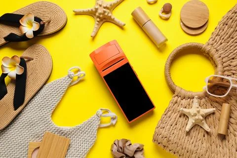 Summer vacation flat lay with a mobile payment terminal, Flip-flops, and beac Stock Photos