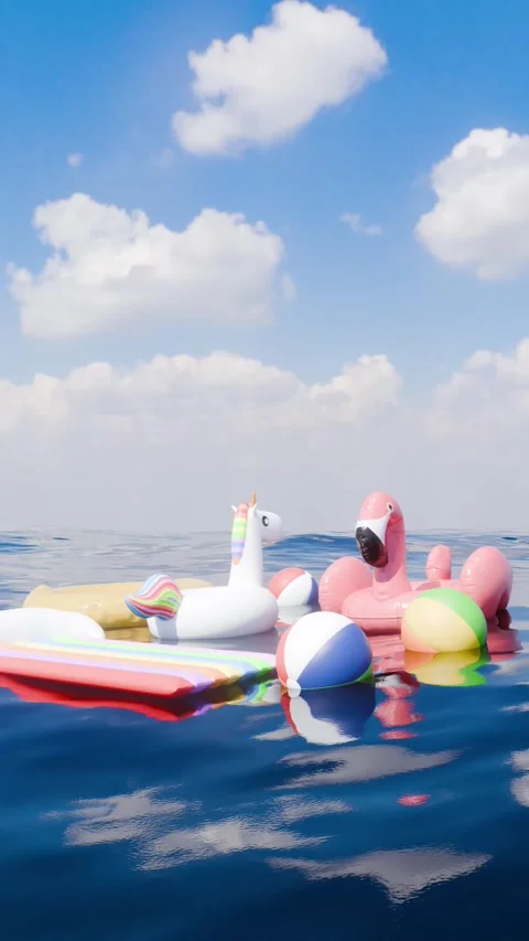 Summer Vacation Scene with Floating Pool Toys at Sea Portrait 库存影片 336295323