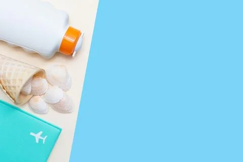 Summer vacation time. Flat lay with sun cream, airplane and seashells. Yellow Stock Photos
