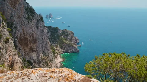 Summer vacations on Capri with limestone cliffs tower above the blue Tyrrhenian Stock Footage 273426322