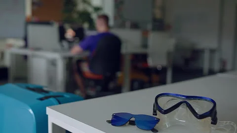Summer vibe. Man working at office with sunglasses and underwater mask on the Stock Footage 109614207
