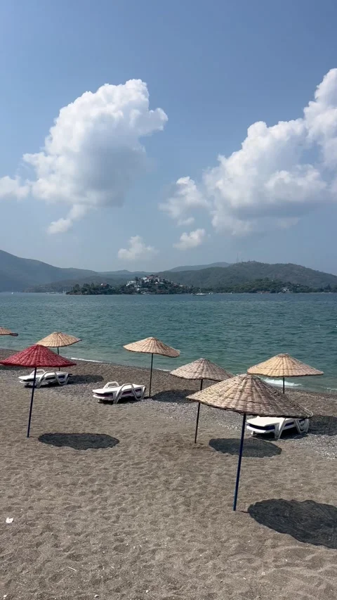 Summer view of a beach with umbrellas and lounge chairs Stock Footage 337124923