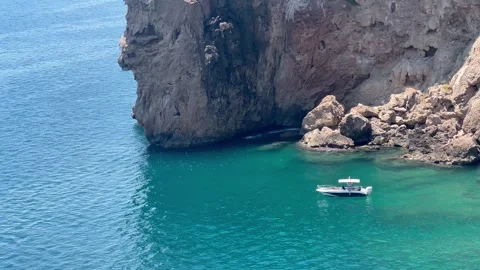 Summer view with a boat in turquoise sea by the coast Stock Footage 337777286