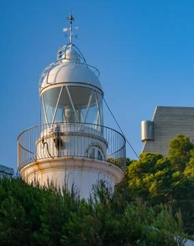 Summer view of the lighthouse surrounded by trees Stock Photos