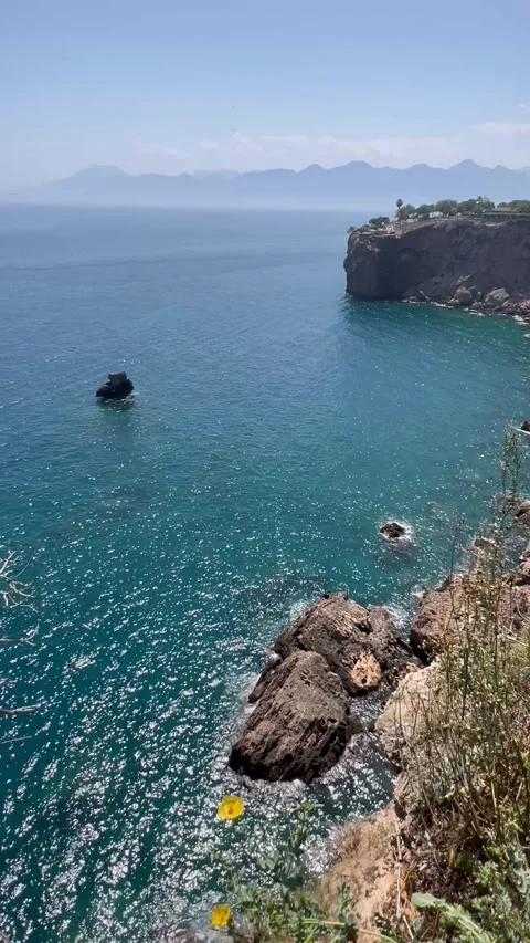 Summer view with rocks in turquoise sea by the coast Stock Footage 337022888