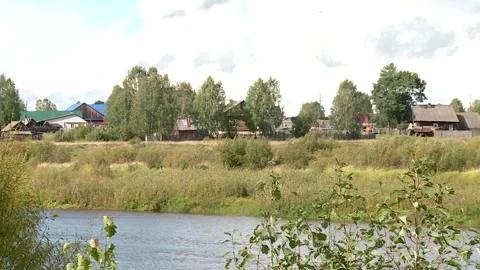 Summer view of the village across the river Stock Footage 340143907