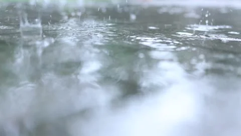 Summer warm rain drops and splashes hit the pavement outdoor. close-up view Stock Footage 158070973