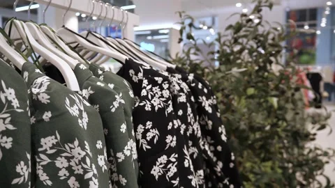 Summer women's shirts with a pattern on a hanger in a store. Stock-Footage 270975513