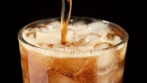 Summertime drinks. Refreshing drink in glass with ice, black background Stock Footage 276479250
