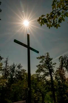Summit cross with beautiful star-shaped sun Stock Photos