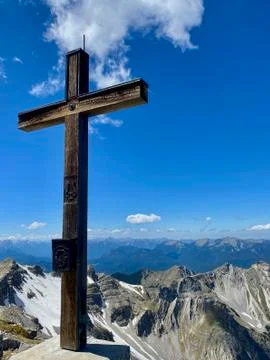 Summit cross of Soiernspitz, mountain view over peaks, blue sky, Bavaria Stock Photos