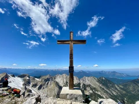 Summit cross of Soiernspitz, mountain view over peaks, blue sky, Bavaria Stock Photos