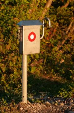 Summit register box with path marking on peak of mountain at sunset Stock Photos