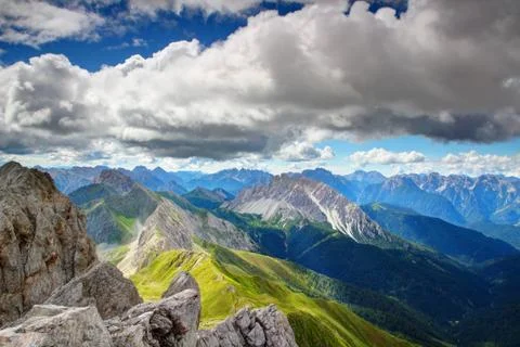 Summit view of Carnic Alps main ridge under fluffy white clouds Stock Photos