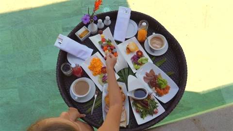 Sumptuous breakfast served on round black table featuring variety of Stock-Footage 271725184