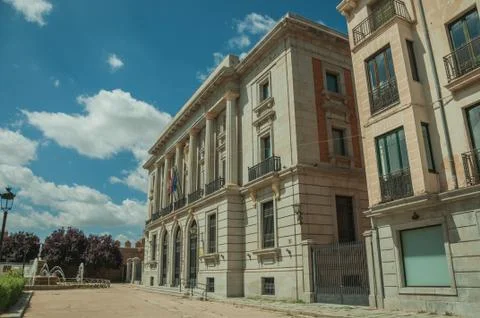 Sumptuous building facade with flags in a square of Avila Stock Photos