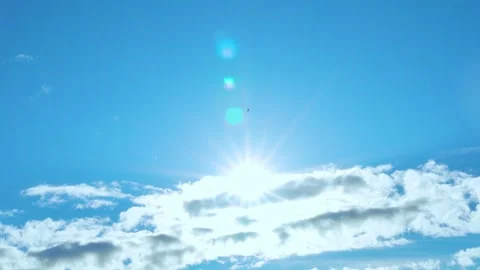 Sun above white clouds in pure blue sky time lapse, motion. Sun closeup, sunshin Stock Footage 314648675