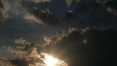 The sun alternately peeks out from time to time behind fast broken clouds Stock Footage 273588656