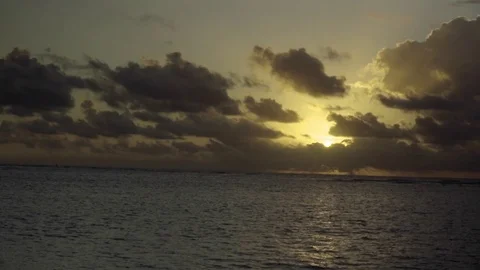 Sun amidst the clouded sky over a calm sea Stock Footage 77804082