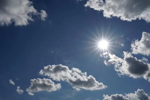 Sun and blue sky with clouds Stock Photos