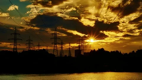 Sun and clouds behind Electric towers with electric wires Stock Footage 70970828