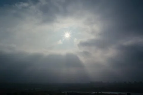 Sun and clouds on a blue sky Stock Photos
