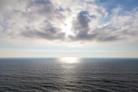 Sun and clouds over the ocean Stock Photos