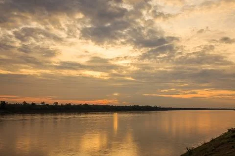 Sun and clouds over river Фото