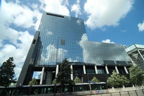 Sun and clouds reflecting in the mirror glass of office Delftse Poort in the  Stock Photos
