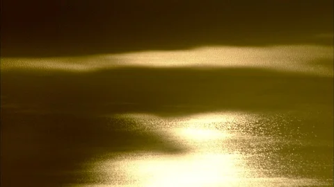 Sun and clouds reflecting on Sea of Galilee with sun high in sky Video stock 95600648