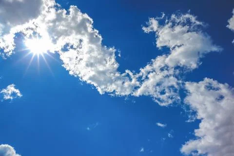 Sun and clouds on sky Stock Photos
