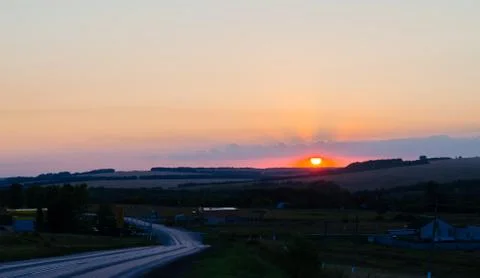 Sun and clouds at sunset Stock Photos