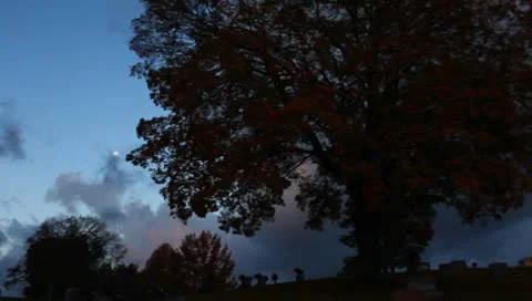 Sun and moon in grave yard Stock Footage 8852486
