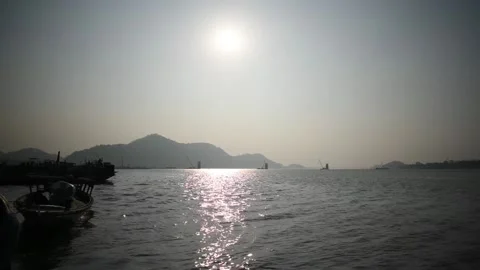 Sun and mountain view from a river bank Stock Footage 170450273
