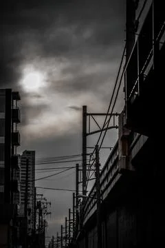 The sun and power lines between the clouds Stock Photos