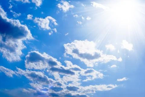 The sun and scattered clouds Stock Photos