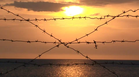 Sun and the sea behind barbed wire Stock Footage 30720701