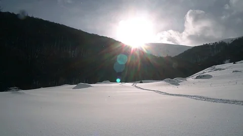 Sun and snow in winter mountains slow motion Stock Footage 99703660