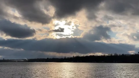 Sun and timelapse clouds with sweeping beams of light w short big lens flare Video stock 265492385