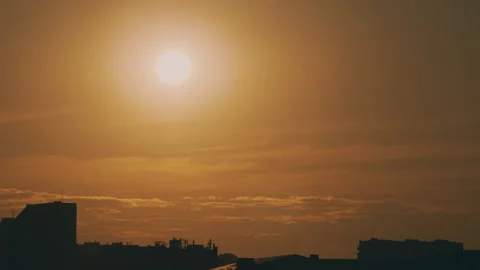Sun and a view of the rooftops of the city. Timelapse Stock Footage 316536954