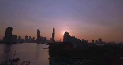 Sun appearing from the skyscraper behind in sunrise flying with drone Video stock 108644575