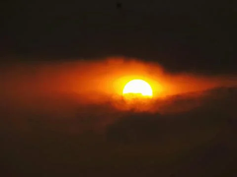 The sun appears among dark clouds Stock Photos