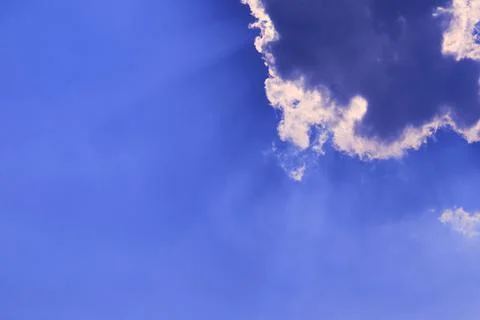 Sun babk on cloud and sunlight shine and passing on purple blue sky Stock Photos