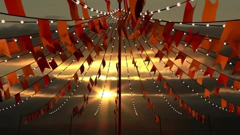 Sun backlighting, breeze animating orange pennants and bulbs, camera revealing Stock Footage 340654583