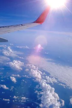 Sun beam with airplane on the blue cloud Stock Photos